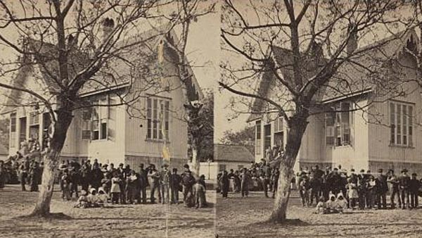 stereoscopic photo of children and teachers outside of a schoolhouse