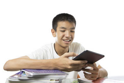 teenager looking at notebooks and tablet device