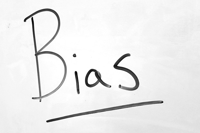the word 'bias' written on a white board