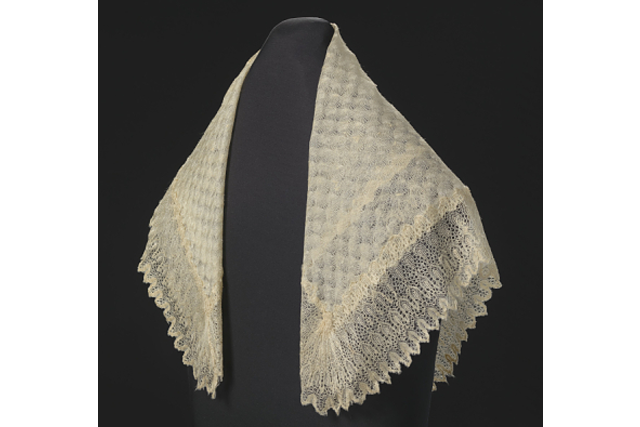 color photograph of a white scarf against a black background