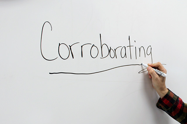 the word 'corroborating' written on a white board